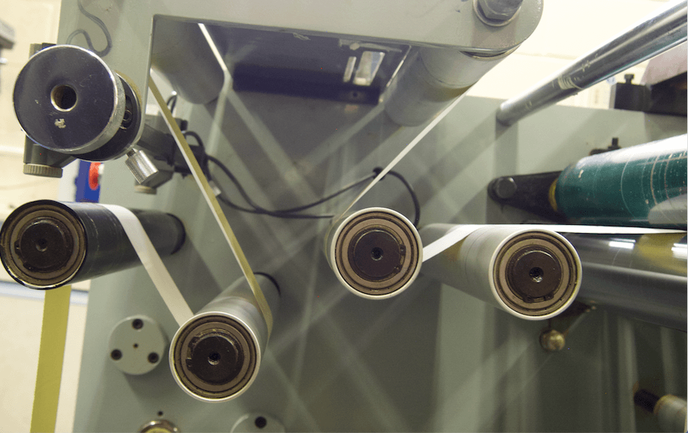 Side view of the round plattens of a slitter machine in A4 Laser Labels Limited's Hot Foil Department